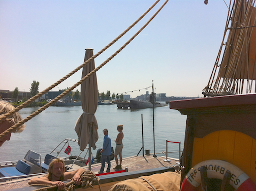 Defunct submarine, background center.  Ferries are gratis over to Amsterdam train station. Captain Andreas climbs aboard.