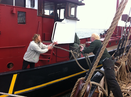 Tres Hombres captain Arjen accepts line from mate Ruud for escorting ship through lock to Ijsselmeer