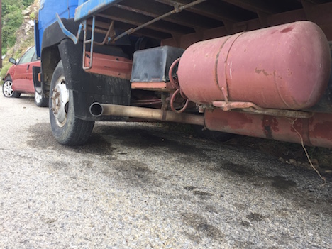 Above a pristine beach, vehicle leaks damage. Photo Jan Lundberg