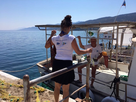 Captain welcomes fresh crew for Mykonos leg. Note STN burgee and signage.