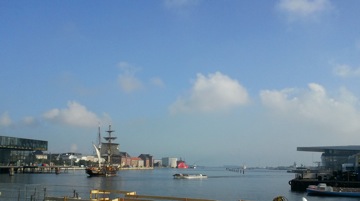 The Tres Hombres sails away from Copenhagen, Aug. 17. Theater building, left; Maersk's opera house, right