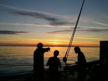 Sunset on a becalmed strait, Sweden off to east